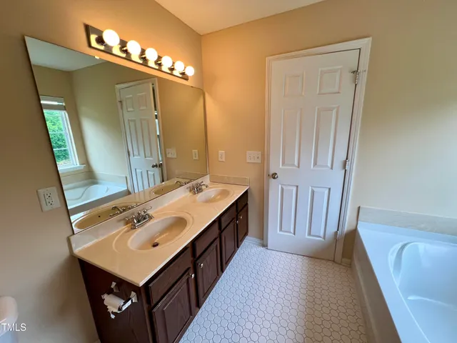 a bathroom with a sink a mirror and a bathtub