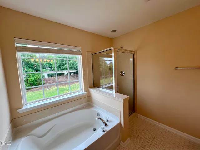 a bathroom with a bathtub and a shower