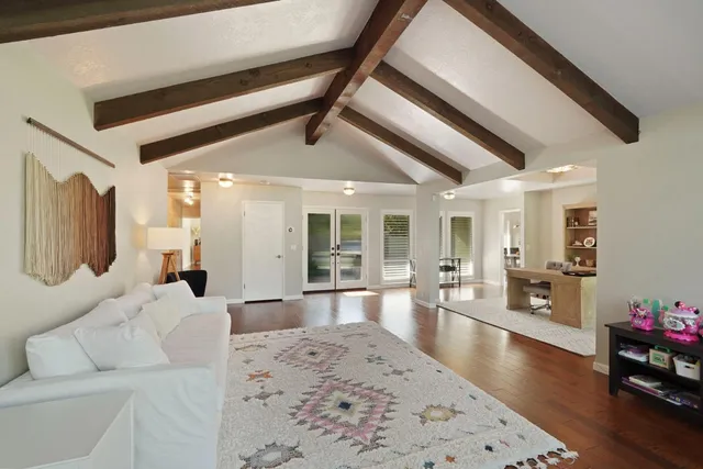 a large kitchen with kitchen island a sink table and chairs