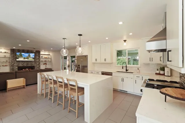 a kitchen with a sink dishwasher and white cabinets