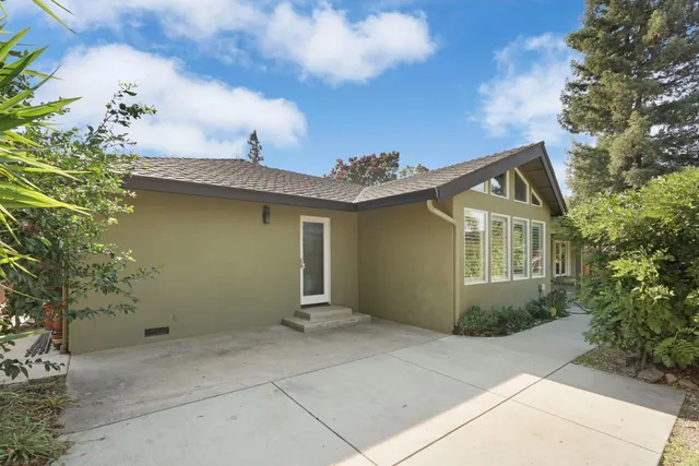 a front view of house with a garden and patio