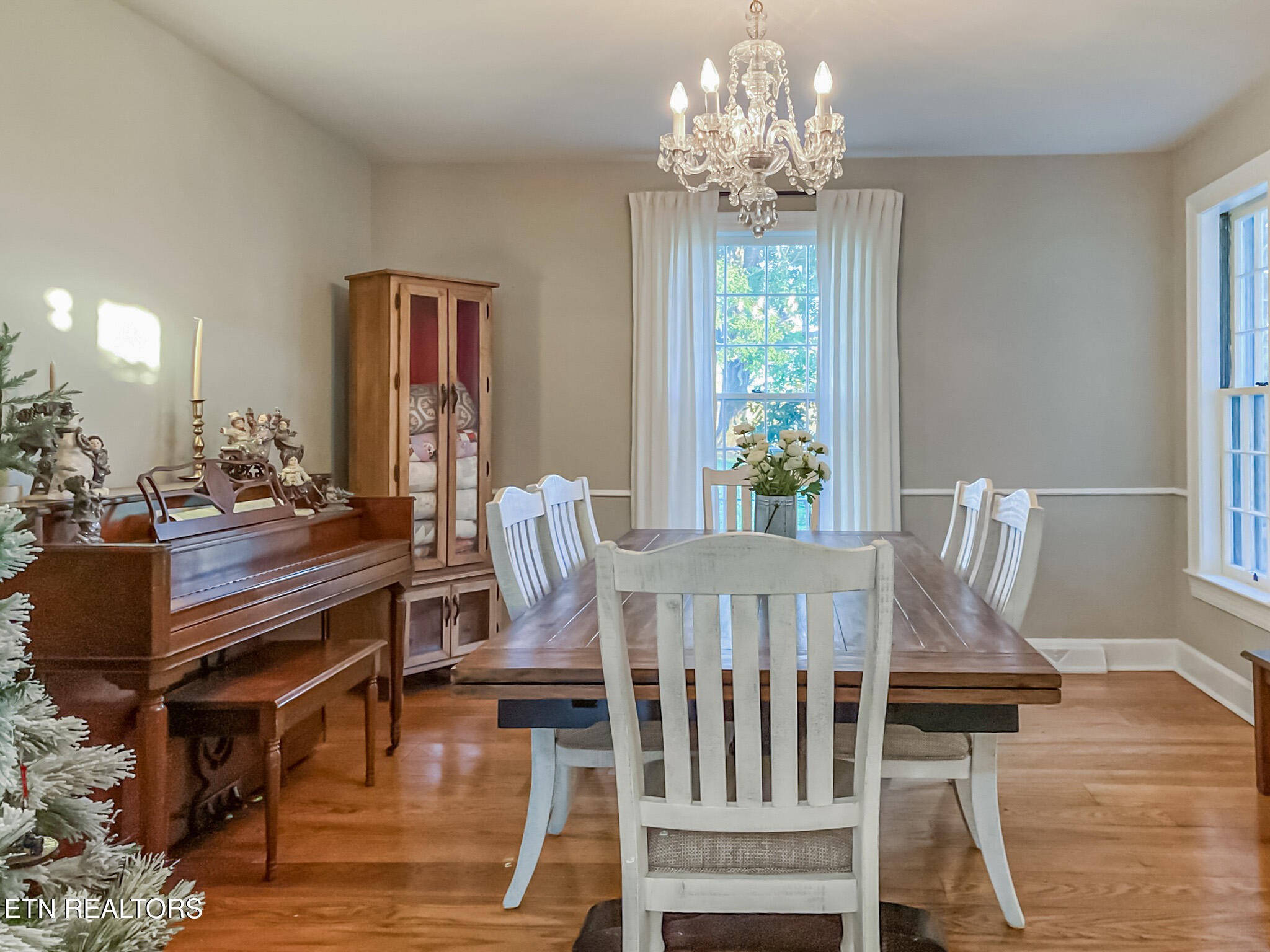 351 Country Club Road La Follette, TN 37766 - Photo 13 of 60 a view of a dining room with furniture a chandelier and wooden floor