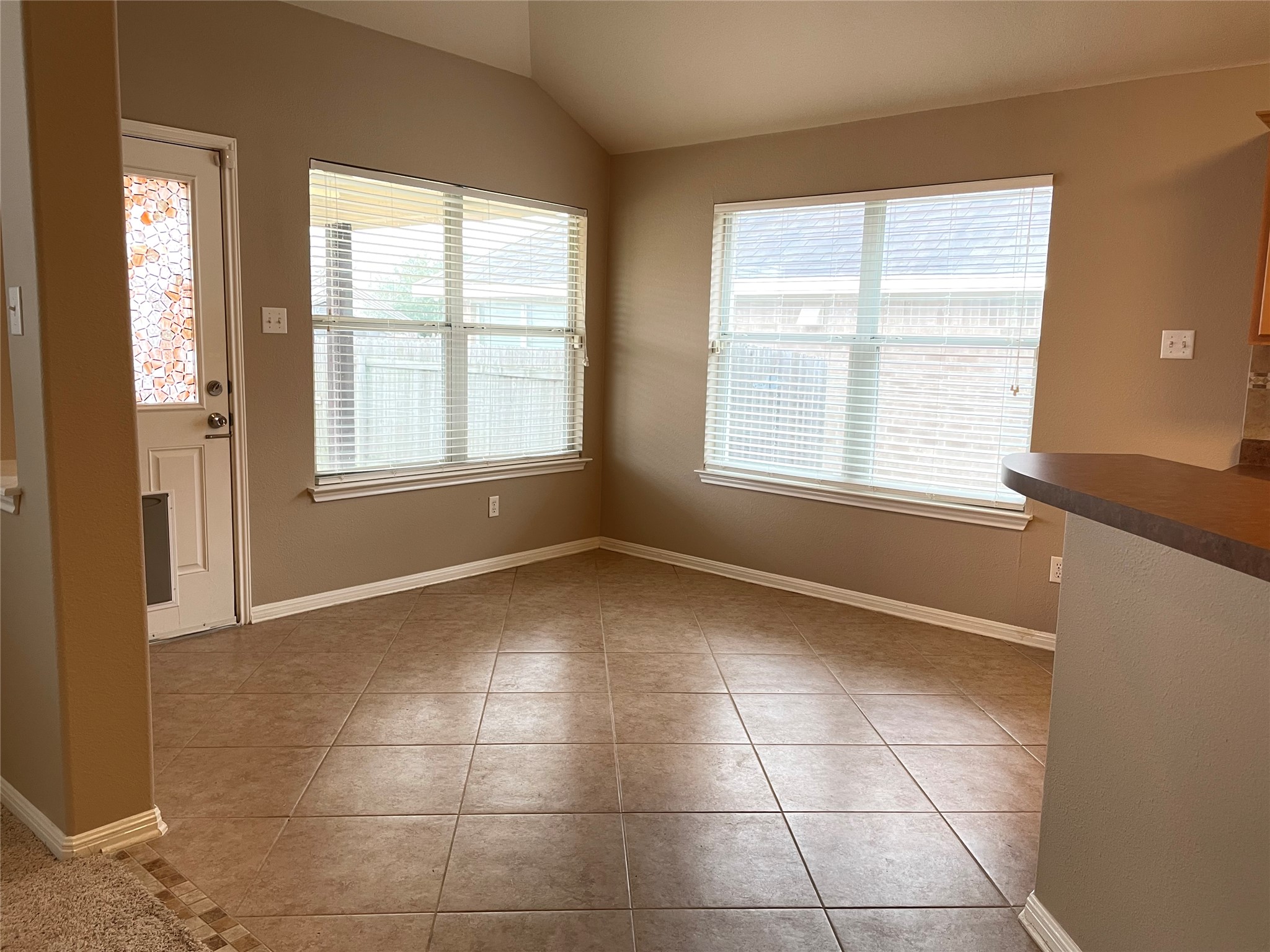11713 Dunblane Way Austin, TX 78754 - Photo 5 of 22 Dining area featuring vaulted ceilings and ceramic tile flooring