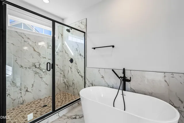 a bathroom with a bathtub and shower