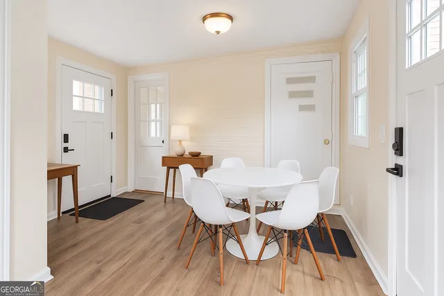 a view of a dining room with furniture and wooden floor