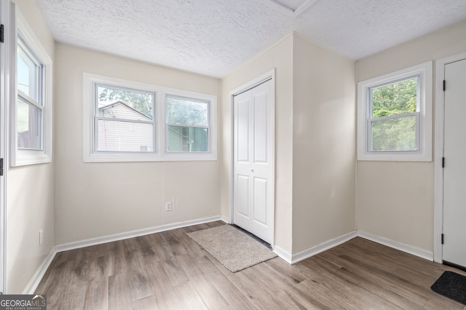 610 Level Grove Road Cornelia, GA 30531 - Photo 4 of 24 an empty room with wooden floor and windows