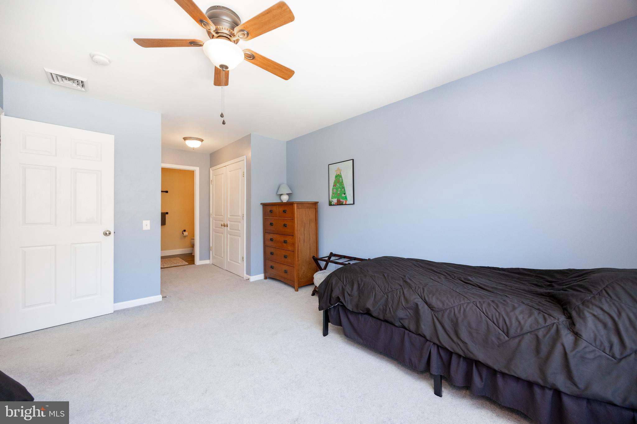 612 Churchill Road Chester Springs, PA 19425 - Photo 21 of 33 a living room with a bed furniture and a ceiling fan