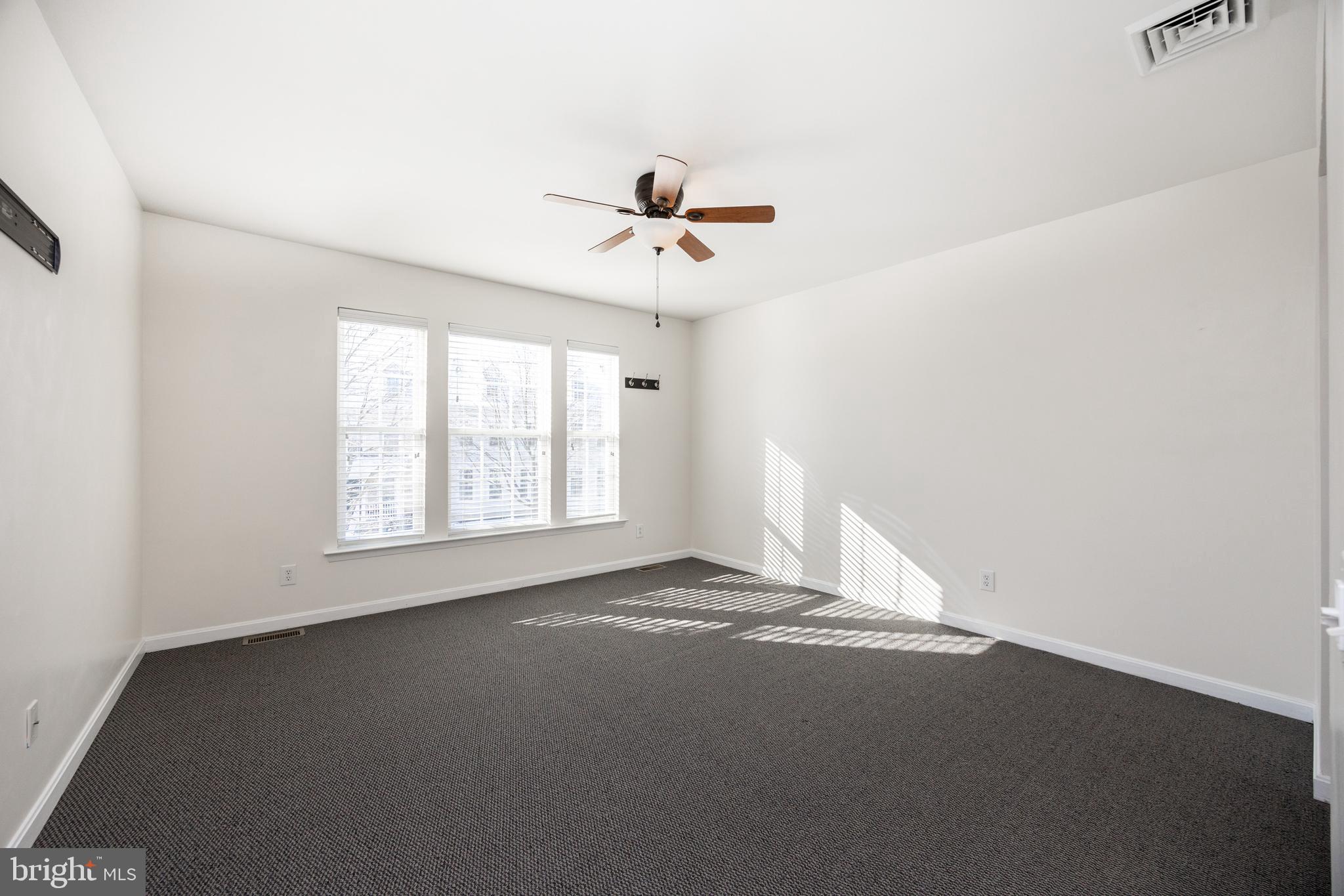 612 Churchill Road Chester Springs, PA 19425 - Photo 24 of 33 an empty room with a window and a ceiling fan
