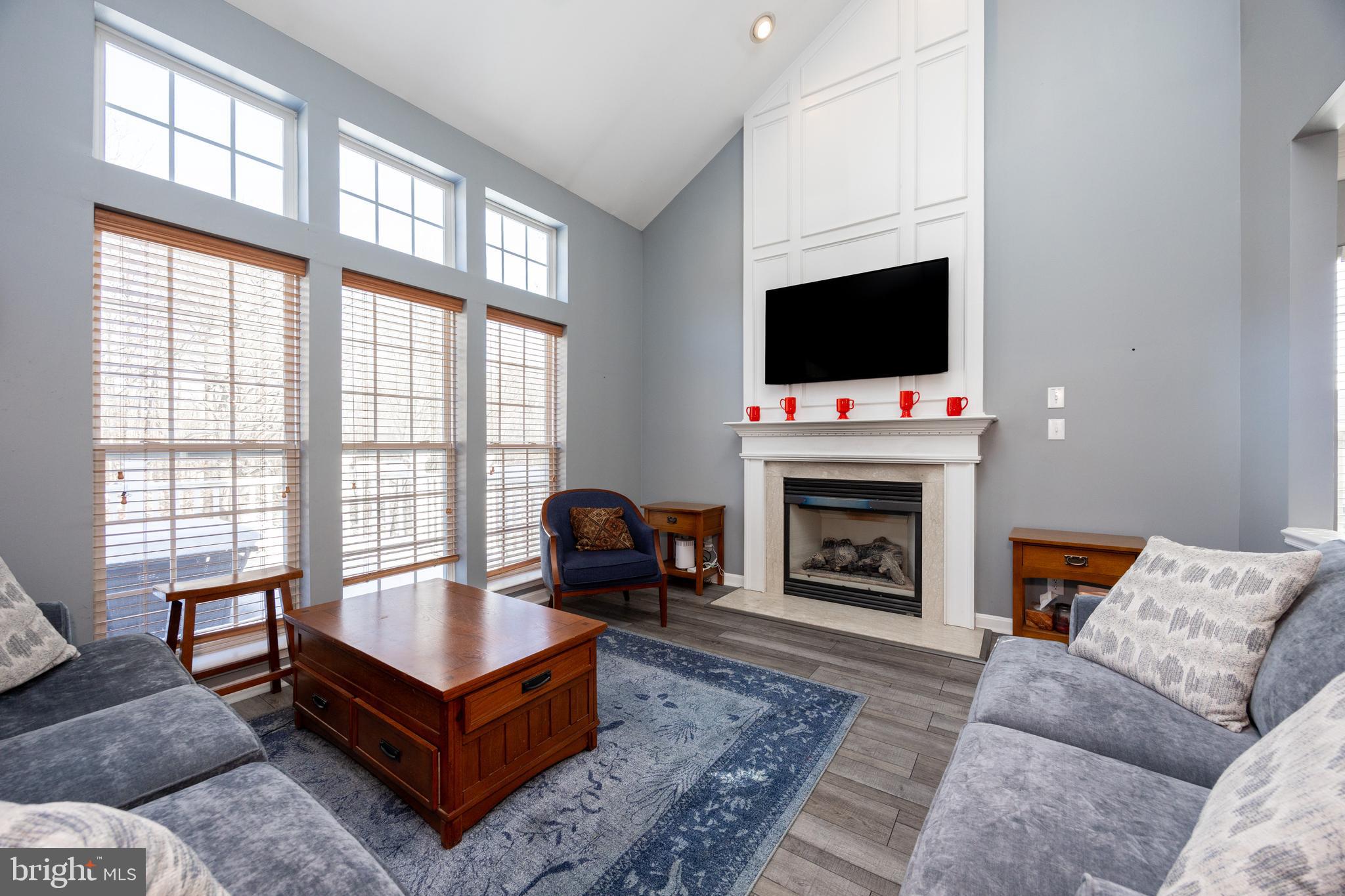 612 Churchill Road Chester Springs, PA 19425 - Photo 8 of 33 a living room with furniture a flat screen tv and a fireplace