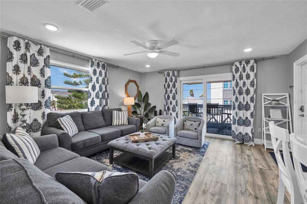 812 Gulf Boulevard, Unit 3 Indian Rocks Beach, FL 33785 - Photo 17 of 62 a living room with furniture and a flat screen tv