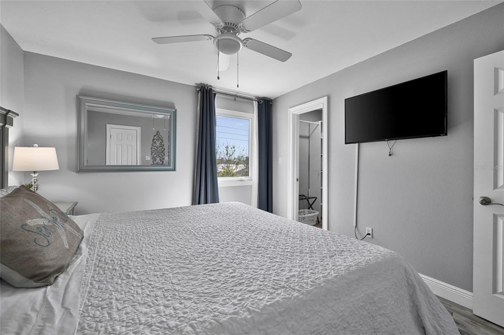 812 Gulf Boulevard, Unit 3 Indian Rocks Beach, FL 33785 - Photo 20 of 62 a bedroom with a large bed and a flat screen tv
