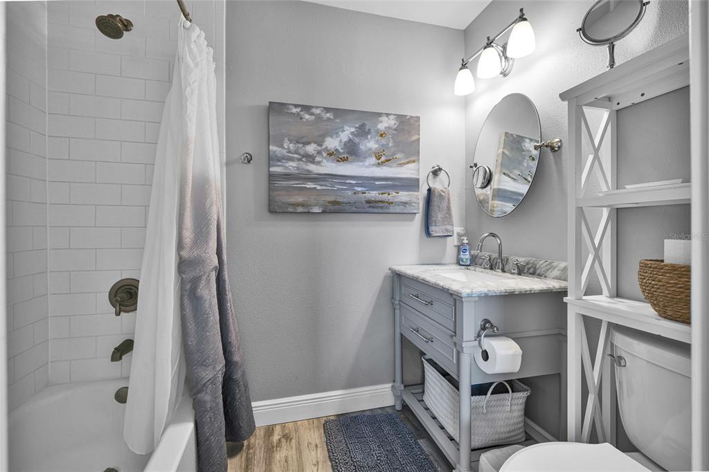 812 Gulf Boulevard, Unit 3 Indian Rocks Beach, FL 33785 - Photo 24 of 62 a bathroom with a sink mirror and a toilet