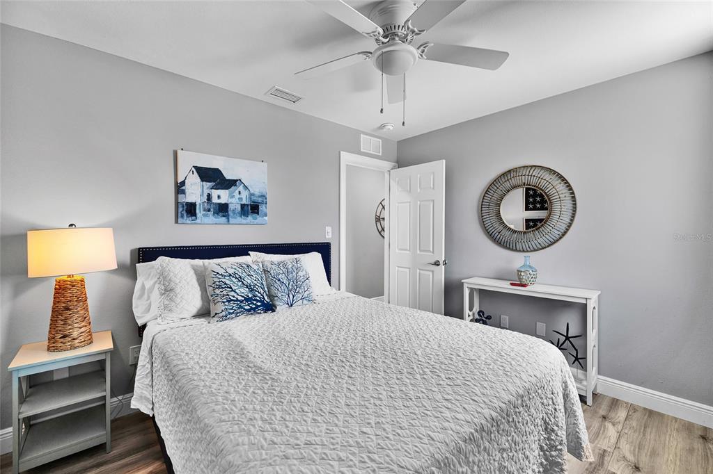 812 Gulf Boulevard, Unit 3 Indian Rocks Beach, FL 33785 - Photo 27 of 62 a bedroom with a bed and a chandelier