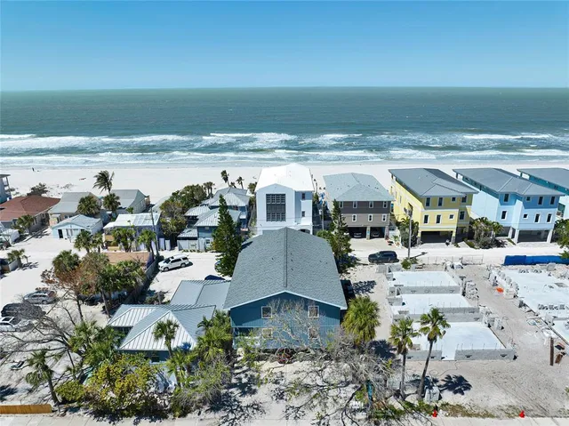 an aerial view of a house with a ocean view