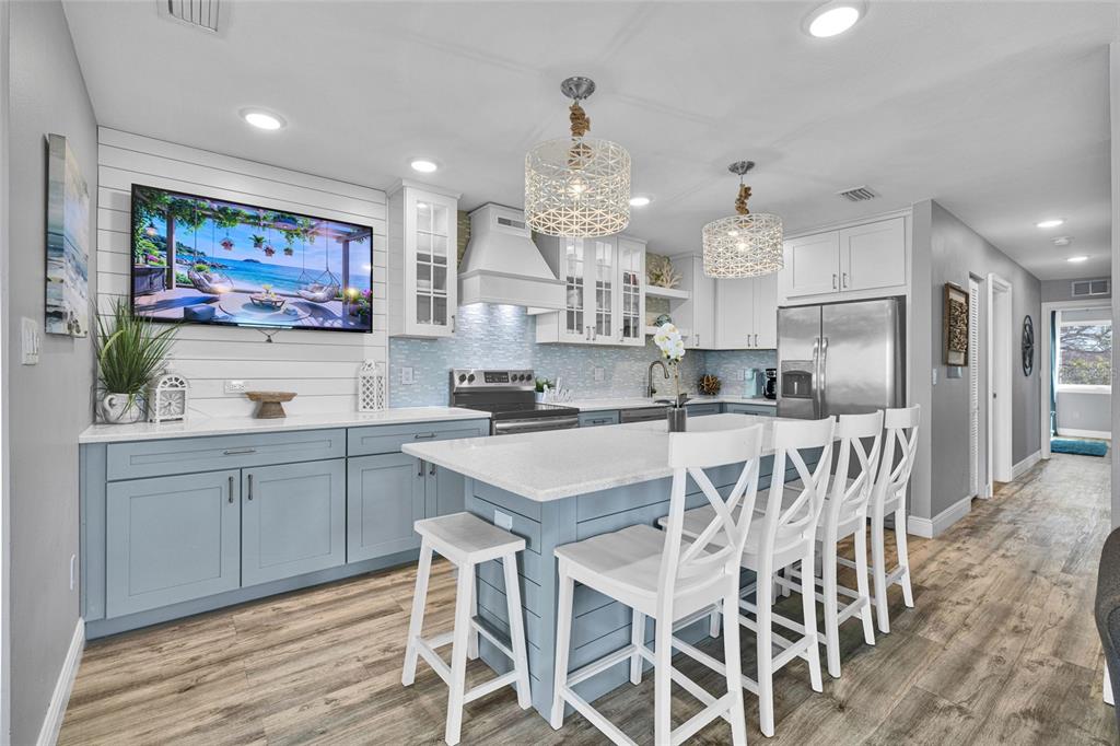 812 Gulf Boulevard, Unit 3 Indian Rocks Beach, FL 33785 - Photo 6 of 62 a kitchen with stainless steel appliances kitchen island granite countertop a sink and cabinets