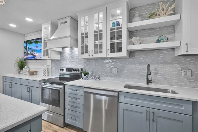 a living room with furniture and a view of kitchen