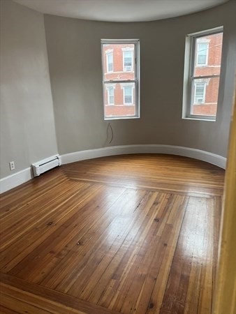 73 Charles Street, Unit 1 Boston, MA 02122 - Photo 3 of 7 a view of a room with wooden floor and window