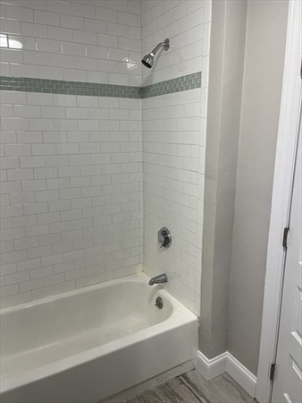 73 Charles Street, Unit 1 Boston, MA 02122 - Photo 4 of 7 a bathroom with a bathtub and shower