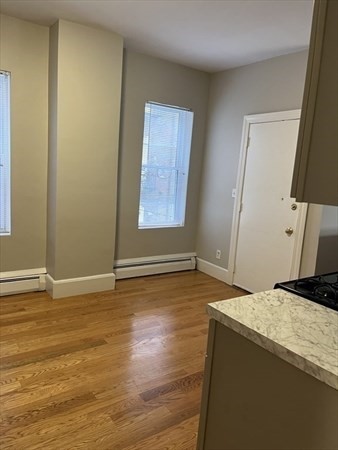 73 Charles Street, Unit 1 Boston, MA 02122 - Photo 6 of 7 a view of room with window and wooden floor