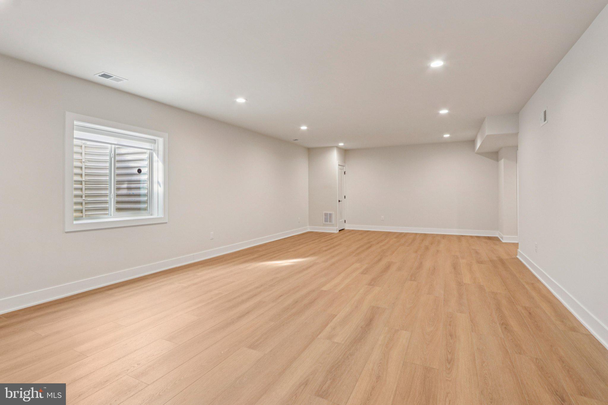 127 Alroy Road Malvern, PA 19355 - Photo 45 of 53 an empty room with wooden floor and windows