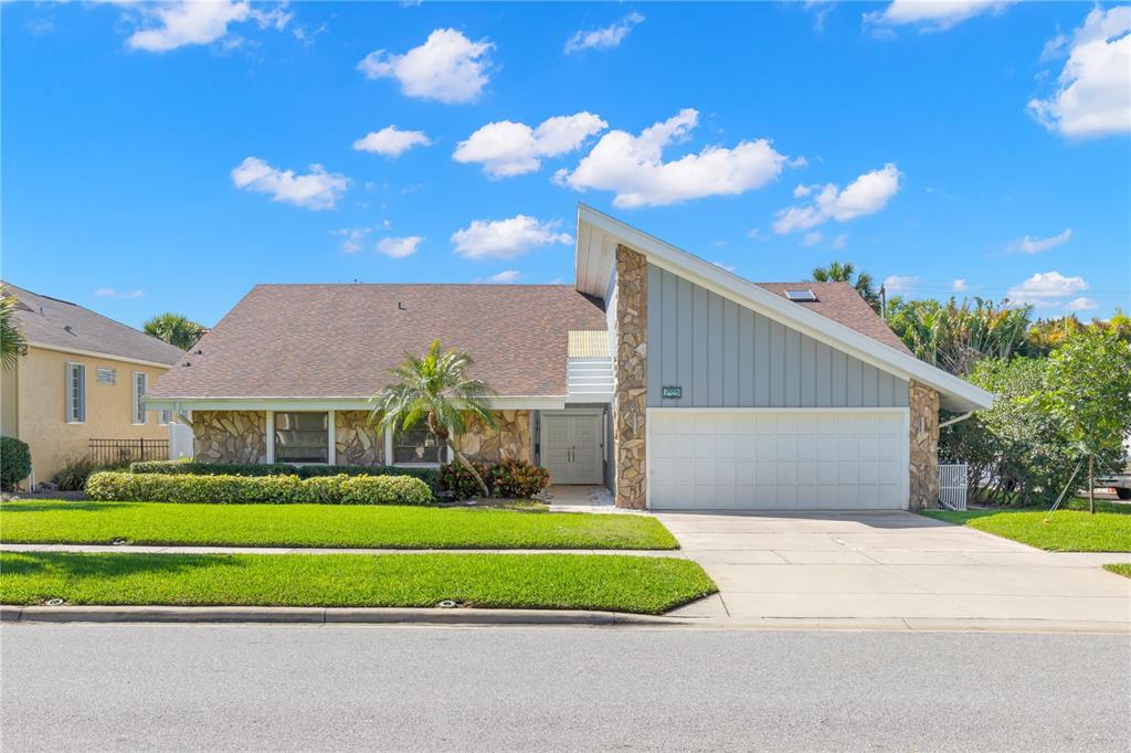 209 Coe Road Belleair, FL 33756 - Photo 1 of 1 a front view of a house with a garden and yard
