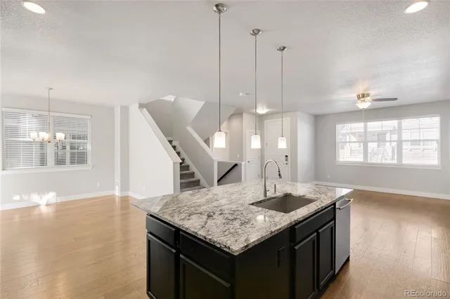 a utility room with granite countertop cabinets and window