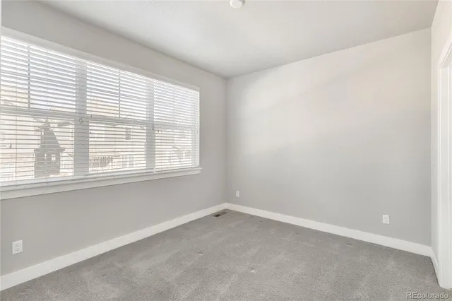 a utility room with a bed and a window