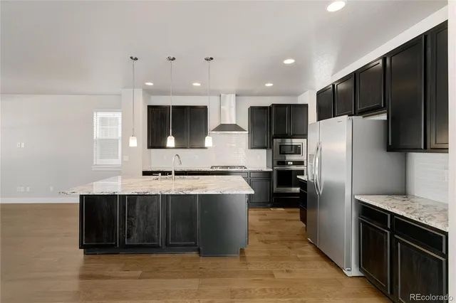 a kitchen with granite countertop a sink a counter space and wooden floor