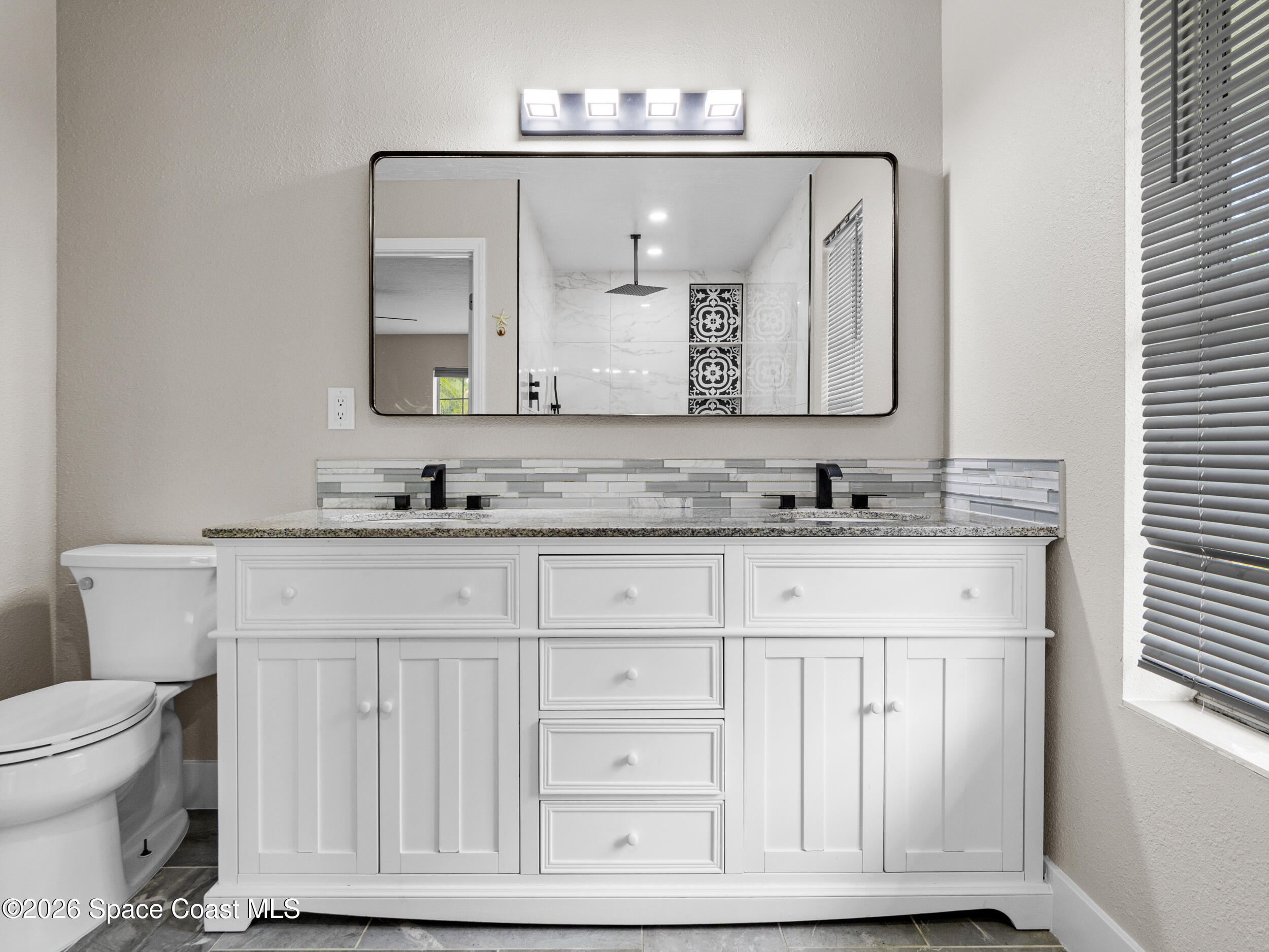 3480 Weber Road Malabar, FL 32950 - Photo 20 of 45 a bathroom with a granite countertop double vanity sink and a mirror