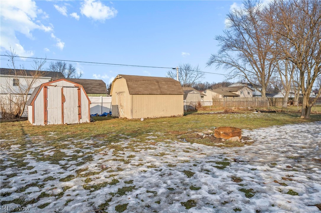 1088 Novak Road Grafton, OH 44044 - Photo 30 of 33 View of yard with a shed, a residential view, and an outdoor fire pit