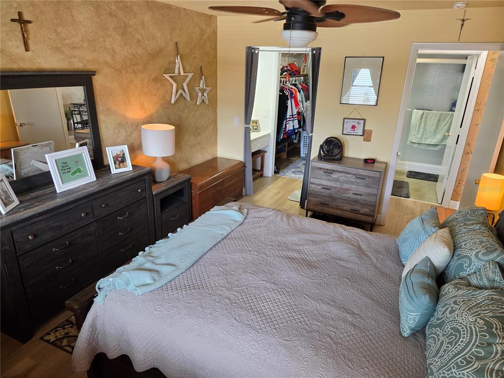 7 Dunoon Place, Unit 309 Dunedin, FL 34698 - Photo 15 of 25 a bedroom with a bed and wooden floor
