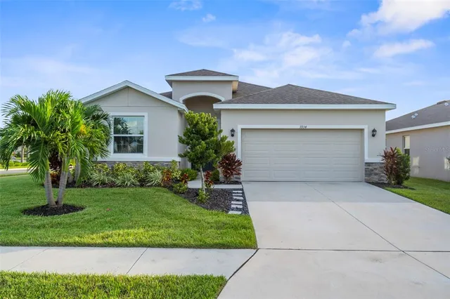 a front view of a house with a yard and garage
