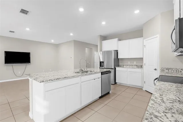 a kitchen with a sink and white cabinets