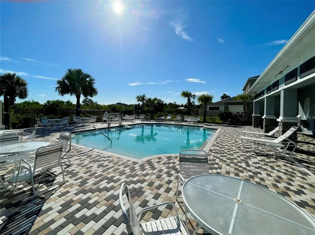 a view of a swimming pool with an outdoor seating