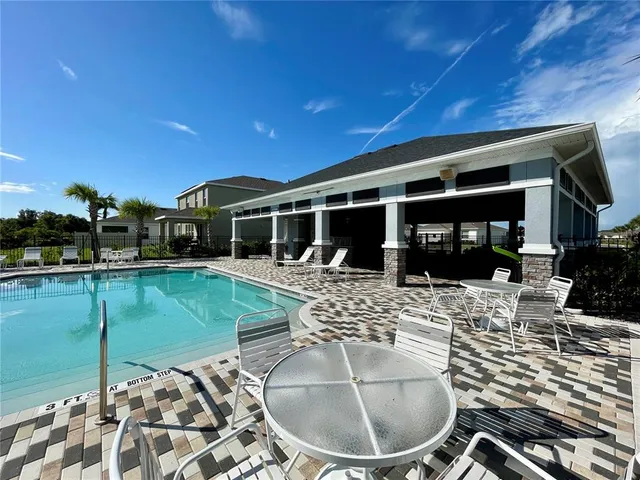 a living room with lots of furniture and a chandelier