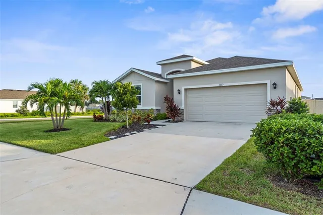 a front view of house with yard and green space