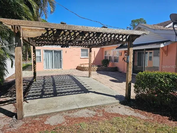 a view of a patio with table and chairs and potted plants