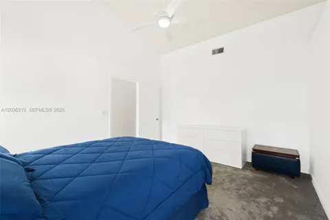 a bedroom with a bed and a night stand