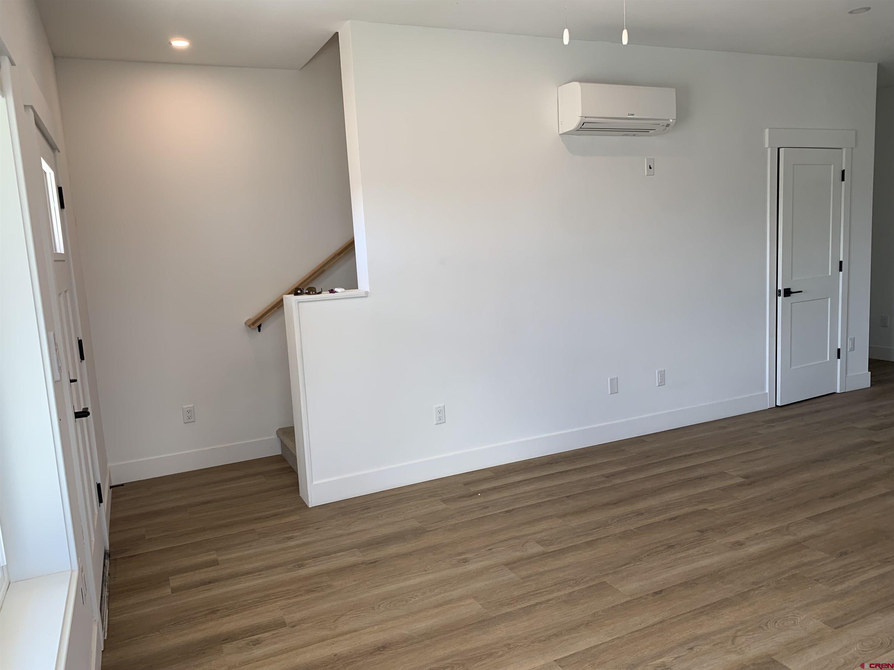 170 Manzano Circle Ignacio, CO 81137 - Photo 10 of 11 wooden floor in an empty room with a window