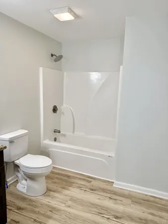 a bathroom with a toilet and a shower
