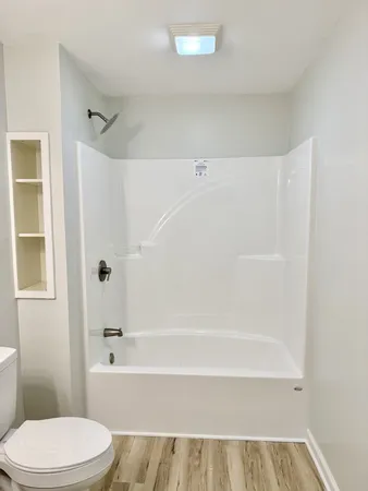 a bathroom with a toilet and a bathtub