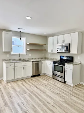 a kitchen with stainless steel appliances cabinets a sink and a stove
