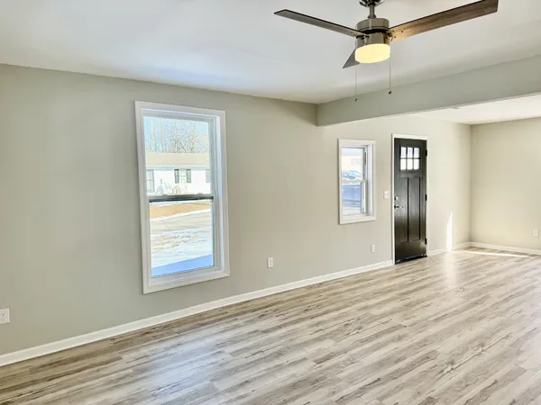 wooden floor in an empty room with a window