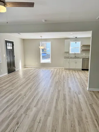 a view of a kitchen with wooden floor