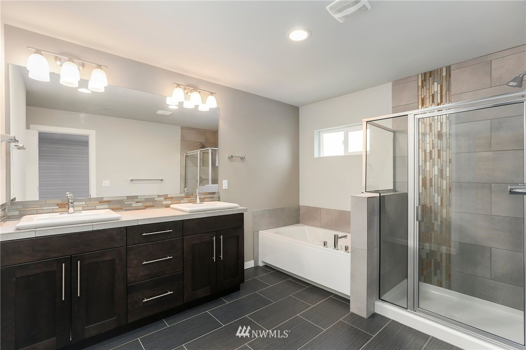 22720 41st Drive Southeast Bothell, WA 98021 - Photo 19 of 33 a bathroom with a double vanity sink and mirror with shower