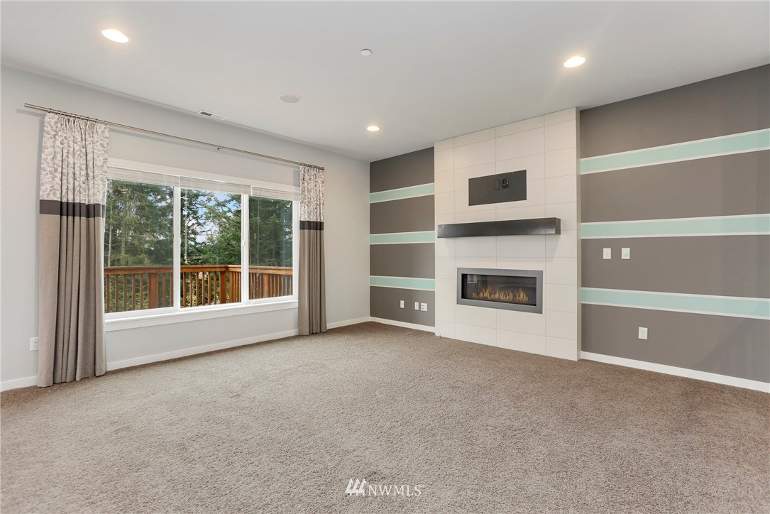 22720 41st Drive Southeast Bothell, WA 98021 - Photo 3 of 33 a view of an empty room with a fireplace and a window