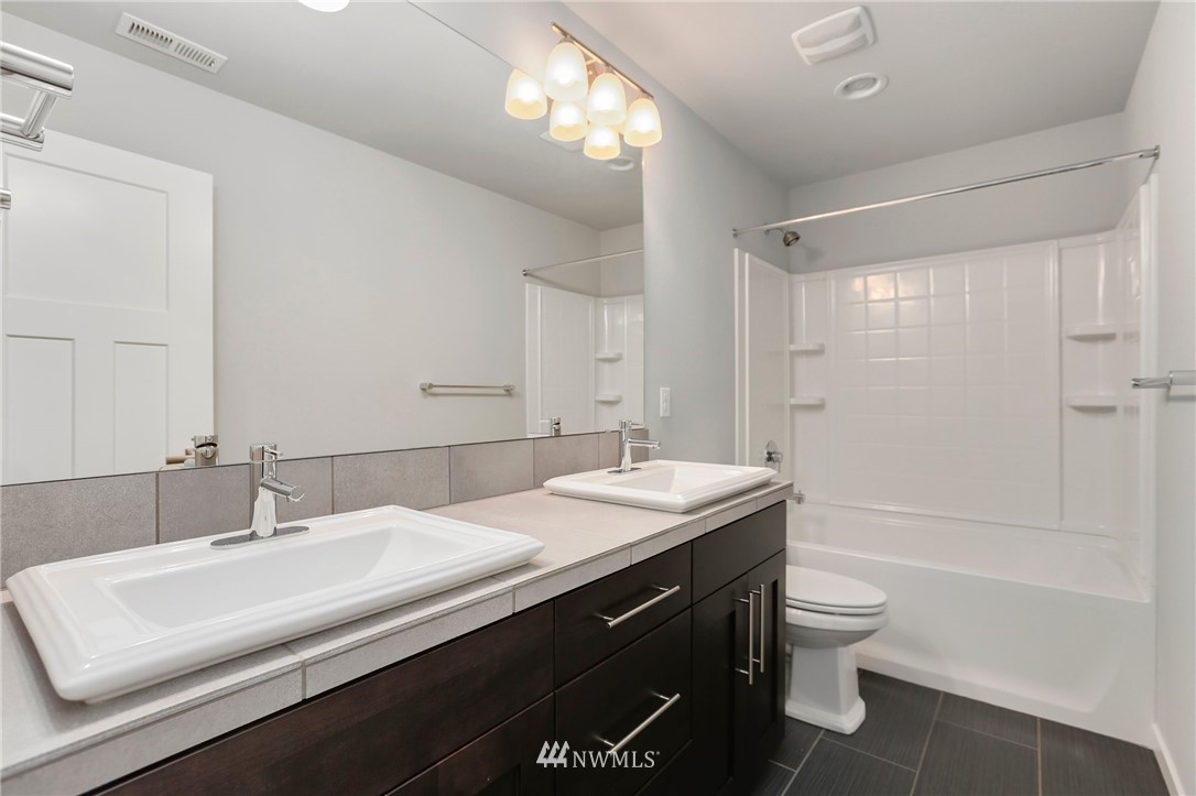 22720 41st Drive Southeast Bothell, WA 98021 - Photo 26 of 33 a bathroom with a sink toilet double vanity and shower