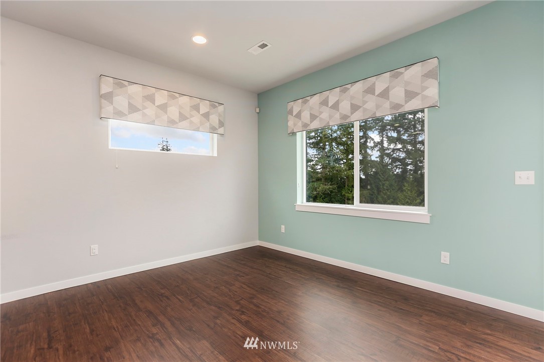 22720 41st Drive Southeast Bothell, WA 98021 - Photo 9 of 33 a view of an empty room with wooden floor and a window