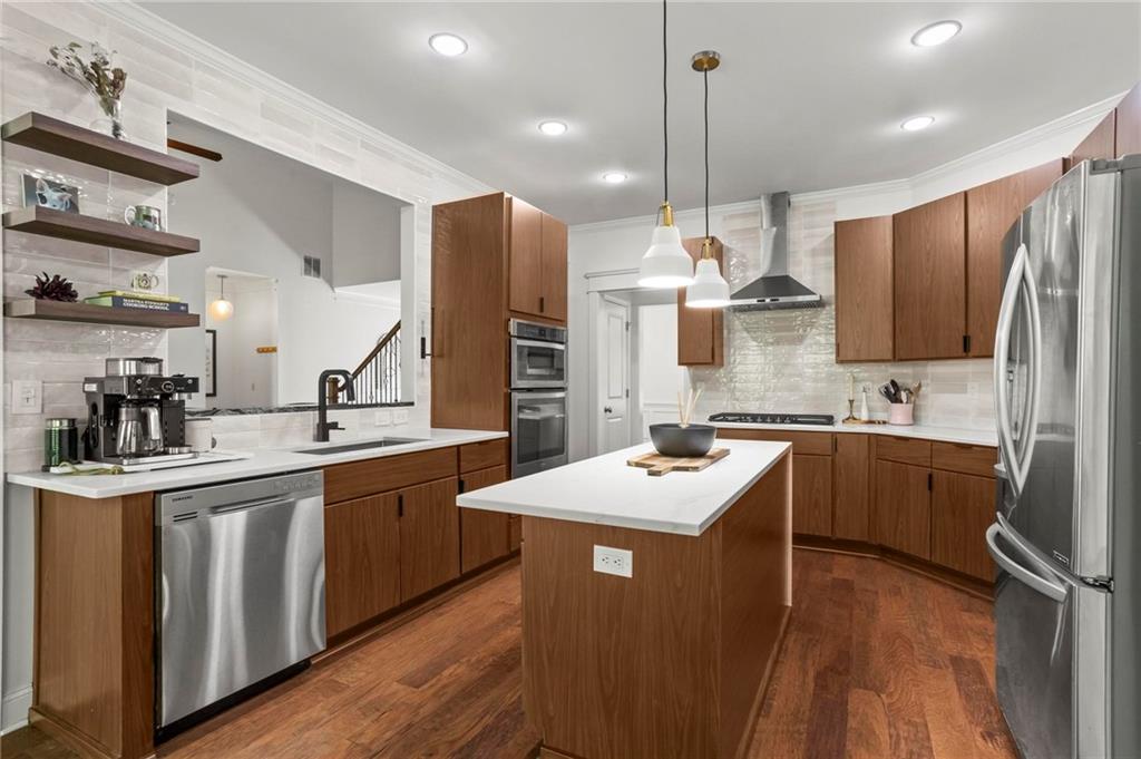 183 Lullwater Lane Dallas, GA 30132 - Photo 12 of 40 a kitchen with stainless steel appliances kitchen island granite countertop a sink stove and refrigerator