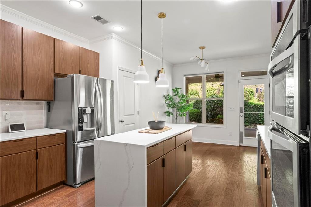183 Lullwater Lane Dallas, GA 30132 - Photo 14 of 40 a kitchen with a sink a counter top space stainless steel appliances a large window and wooden floor
